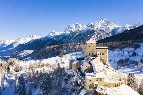 Aerial view of Tarasp castle after snowfall. Tarasp, Lower Engadine, Canton of Grisons, Switzerland, Europe.