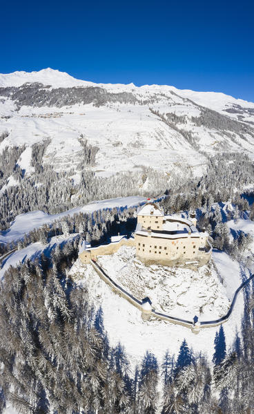 Aerial view of Tarasp castle after snowfall. Tarasp, Lower Engadine, Canton of Grisons, Switzerland, Europe.