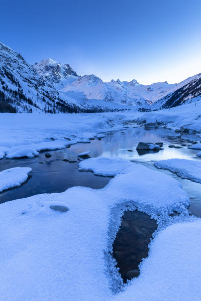 Moonlight illuminates the Val Roseg at dusk. Pontresina, Val Roseg, Engadine, Canton of Grisons, Switzerland, Europe.