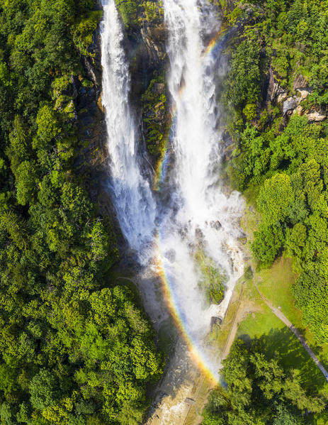 Aerial view of Acquafraggia Waterfall in spring with a rainbow. Valchiavenna, Valtellina, Lombardy, Italy, Europe.