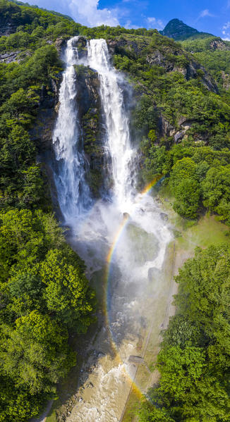 Aerial view of Acquafraggia Waterfall in spring with a rainbow. Valchiavenna, Valtellina, Lombardy, Italy, Europe.