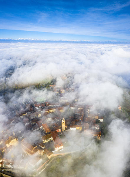 The village of La Morra emerges from the fog. Barolo wine region, Langhe, Piedmont, Italy, Europe.