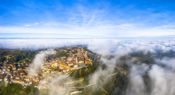 The village of La Morra emerges from the fog. Barolo wine region, Langhe, Piedmont, Italy, Europe.