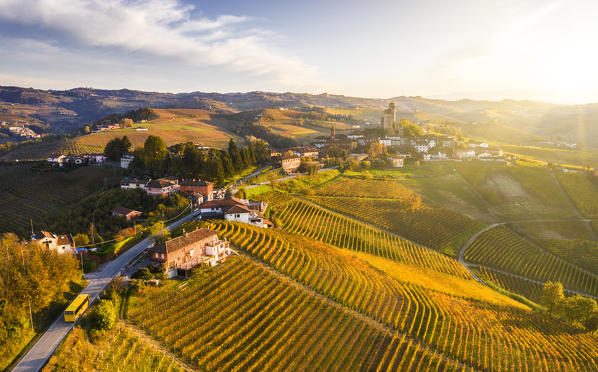 Yellow bus transit at Serralunga d'Alba at sunset.  Serralunga d'Alba, Langhe, Piedmont, Italy, Europe.