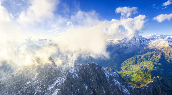 Aerial view of foggy scenery with Pizzo Arera and Colle di Zambla in the background. Val Seriana, Orobie, Lombardy, Italy, Europe.