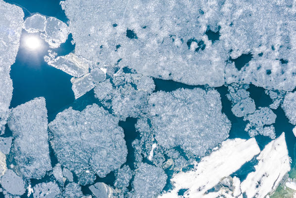 Aerial zenithal view of the summer thaw of Lago Pirola. Valmalenco, Valtellina, Sondrio province, Lombardy, Italy, Europe.