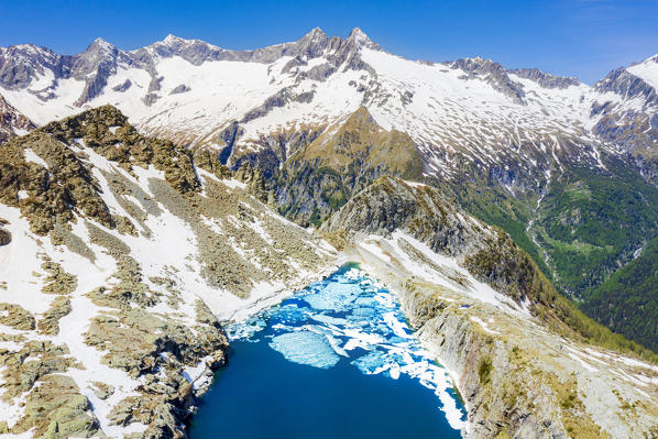 Aerial view of Lago Pirola in summer thaw. Chiareggio, Valmalenco, Valtellina, Sondrio province, Lombardy, Italy, Europe.