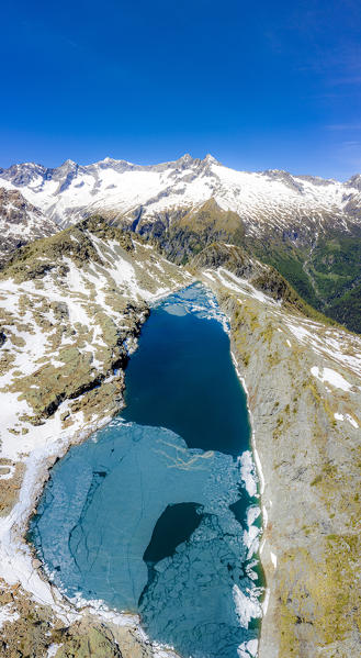 Aerial view of Lago Pirola in summer thaw. Chiareggio, Valmalenco, Valtellina, Sondrio province, Lombardy, Italy, Europe.