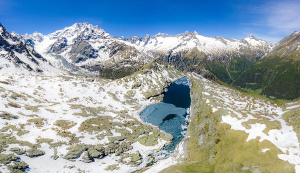 Aerial view of Lago Pirola in summer thaw. Chiareggio, Valmalenco, Valtellina, Sondrio province, Lombardy, Italy, Europe.