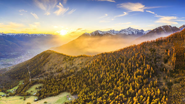 Aerial view of foggy sunset. Valtellina, Lombardy, Italy, Europe