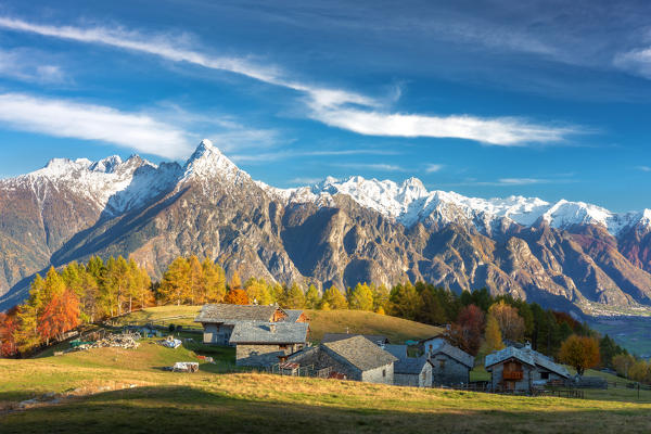 Alpine village of Cermine with view on snowcapped mountains. Valchiavenna, Valtellina, Lombardy, Italy, Europe.