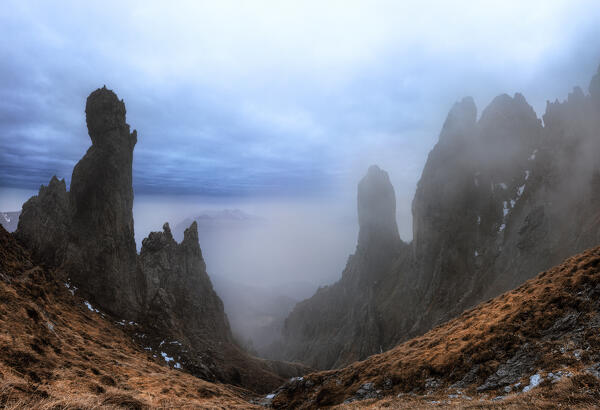 Rock pinnacles in the fog at twilight.Grignetta, Grigne group, Lake Como, Lombardy, Italy, Europe