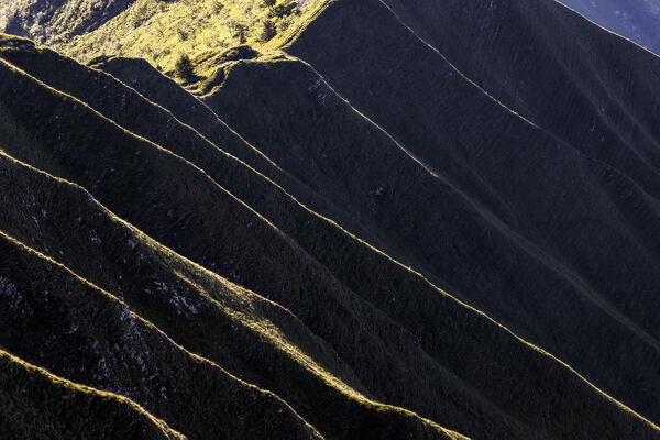 Illuminated ridges. Cima Pari, Alpi Ledrensi, Trento province, Trentino Alto Adige, Italy, Europe.