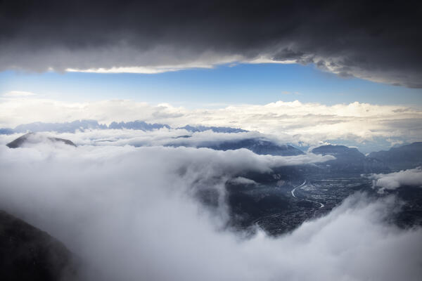 Fog and clouds after rain with view on the Adige river and Brenta group. Altopiano della Vigolana, Trento province, Trentino Alto Adige, Italy, Europe.