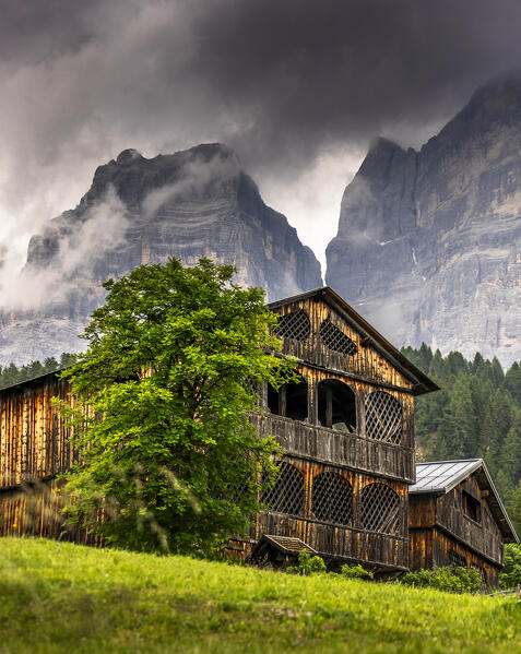 Traditional rustic wooden houses in the village of Coi in Val di Zoldo,  with Mount Pelmo behind. Zoldo valley, Cadore, Belluno province, Veneto, Italy, Europe.