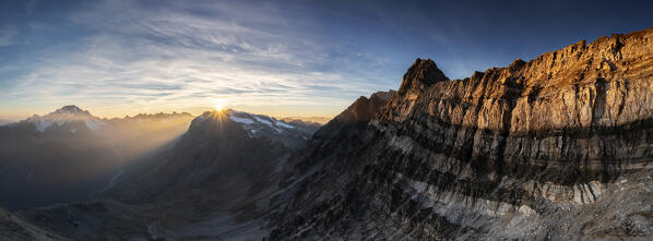 Aerial panoramic view of Sassa d'Entova peak with view on the sunset. Valmalenco, Valtellina, Lombardy, Italy, Europe