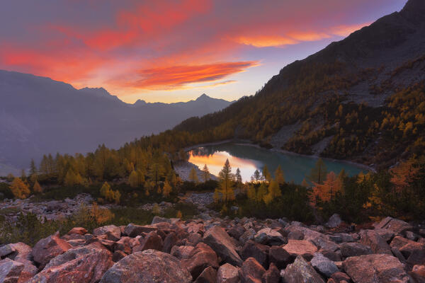 Autumnal sunrise at Lake Lagazzuolo. Valmalenco, Valtellina, Lombardy, Italy, Europe.