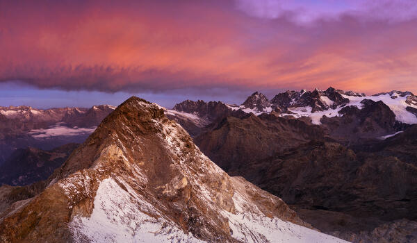 Aerial view of Pizzo Scalino at sunrise with view on Bernina group. Valmalenco, Valtellina, Lombardy, Italy, Europe.