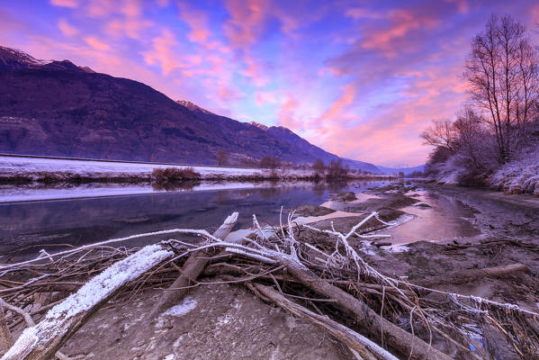 Sunset on the side of the Adda River. Fusine, Valtellina, Lombardy, Italy.