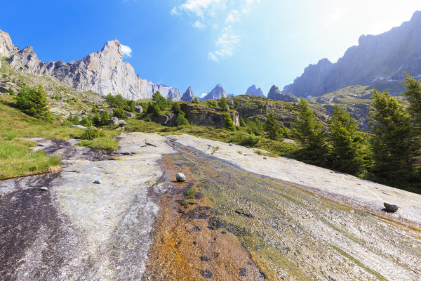 A water ripple flows on a rock plain in Torrone Valley, Valmasino, Valtellina, Sondrio province, Lombardy, Italy.