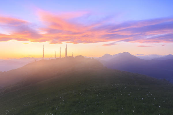 Television antennas in the fog during stunning sunset.  Valico di Valcava(Valcava Pass), Val San Martino, Prealpi Bergamasche, Bergamo province, Lombardy, Italy.