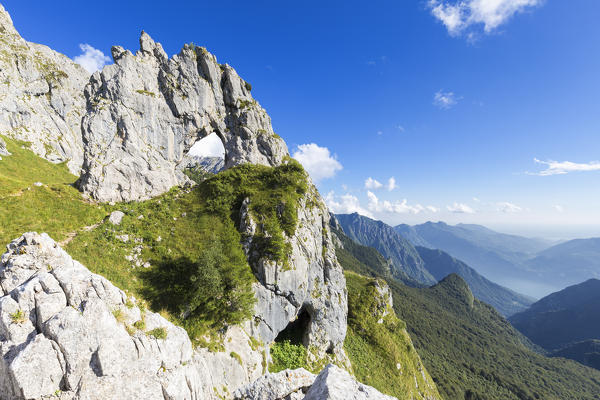 The Porta di Prada,  a rock natural arch in the Grigna group. Grigna Settentrionale(Grignone), Northern Grigna Regional Park, Lombardy, Italy, Europe.