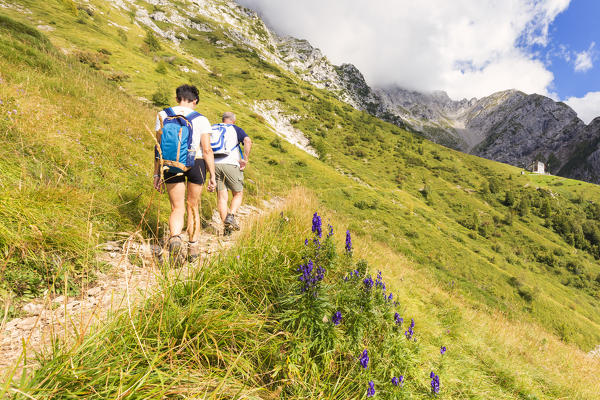 Hikers walk on a path to Rifugio Bietti Buzzi, Grigna Settentrionale(Grignone), Northern Grigna Regional Park, Lombardy, Italy, Europe.