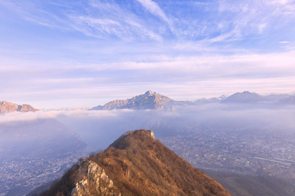 City of Lecco and the village of Valmadrera under the morning fog. Monte Barro Regional Park, Brianza, Lombardy, Italy, Europe.