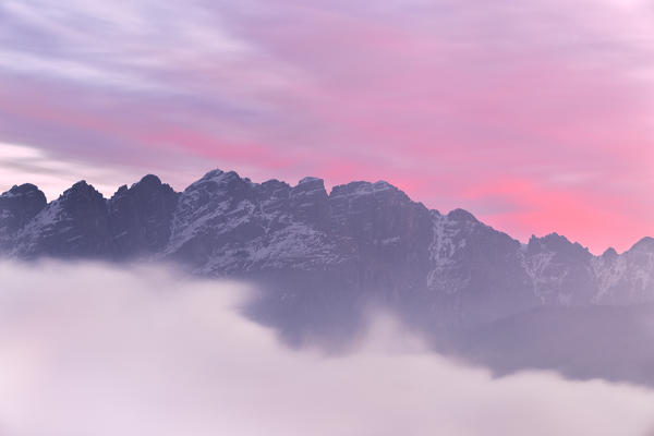 Colorful sunrise over Monte Resegone in a foggy morning. Lecco, Brianza, Lombardy, Italy, Europe.