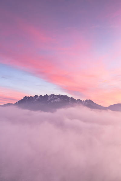 Colorful sunrise over Monte Resegone in a foggy morning. Lecco, Brianza, Lombardy, Italy, Europe.