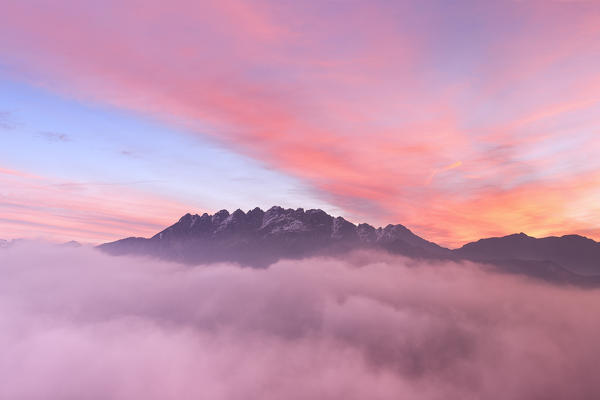 Colorful sunrise over Monte Resegone in a foggy morning. Lecco, Brianza, Lombardy, Italy, Europe.