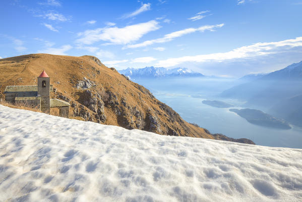 Last snow at San Bernardo Church, Monte Bregagno, Dongo, Como Lake, Lombardy, Italy, Europe.