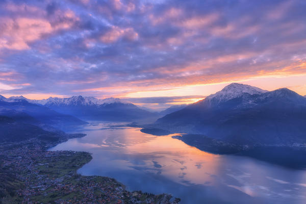 Stunning sunrise over the village of Dongo and Como Lake, from above. San Bernardo Church, Monte Bregagno, Dongo, Como Lake, Lombardy, Italy, Europe.