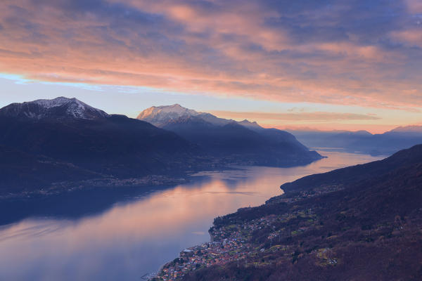 Stunning sunrise over Como Lake. San Bernardo Church, Monte Bregagno, Dongo, Como Lake, Lombardy, Italy, Europe.