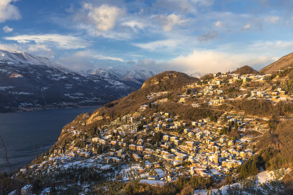 Village of Perledo illuminates by the sun after a snowfall. Como Lake, Lombardy, Italy, Europe.