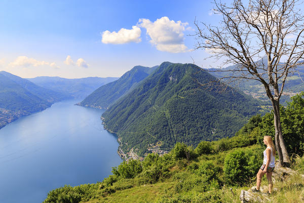 A girl looks the Como Lake from above. Pigra, Val d'Intelvi, Como Lake, Lombardy, Italy, Europe.