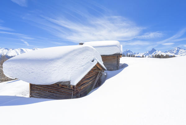 Typical alpine huts after a heavy snowfall. Wiesner Alp, Davos Wiesen, Landwasser Valley, Albula Valley, District of Prattigau/Davos, Canton of Graubünden, Switzerland, Europe.