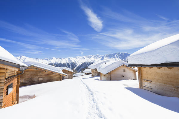 Typical alpine huts after a heavy snowfall. Wiesner Alp, Davos Wiesen, Landwasser Valley, Albula Valley, District of Prattigau/Davos, Canton of Graubünden, Switzerland, Europe.