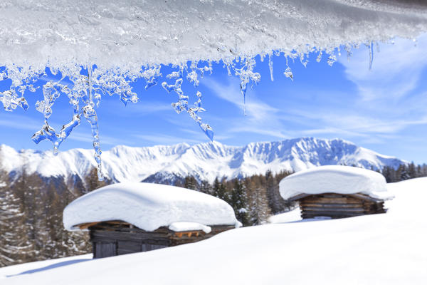 Transparent ice runs from a roof. Wiesner Alp, Davos Wiesen, Landwasser Valley, Albula Valley, District of Prattigau/Davos, Canton of Graubünden, Switzerland, Europe.