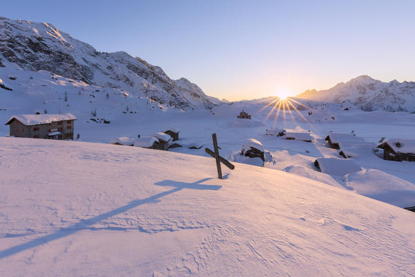 Winter sunset at Alpe Prabello with Mount Disgrazia in the background. Malenco Valley, Valtellina, Lombardy, Italy, Europe