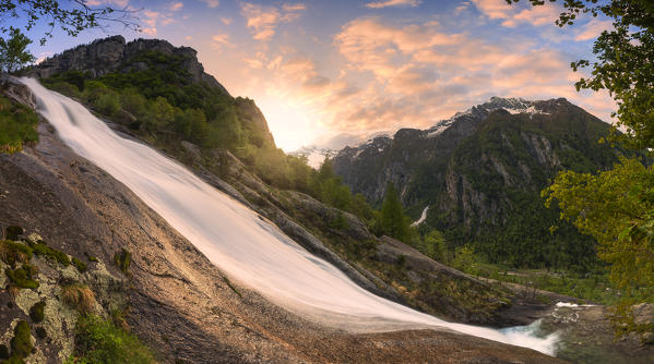 Val del Ferro Waterfall during colourful sunrise. Val di Mello(Mello Valley), Valmasino, Valtellina, Lombardy, Italy, Europe.