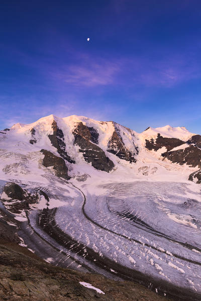 Palu Peaks during sunrise with Vedret Pers Glacier in the foreground. Diavolezza Refuge, Bernina Pass, Engadin, Graubünden, Switzerland, Europe.