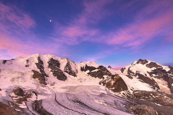 Palu Peaks and Piz Bernina during sunrise with Vedret Pers and Morterasch Glacier in the foreground. Diavolezza Refuge, Bernina Pass, Engadin, Graubünden, Switzerland, Europe.