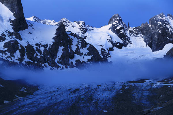 Fog on the Forno Glacier with Torrone Peaks in the background. Forno Glacier, Forno Valley, Maloja Pass, Engadin, Graubünden, Switzerland, Europe.