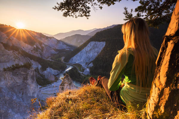 Young girl looks the sunrise above Rhine Gorge(Ruinaulta), Flims, District of Imboden, Canton of Grisons, Switzerland, Europe