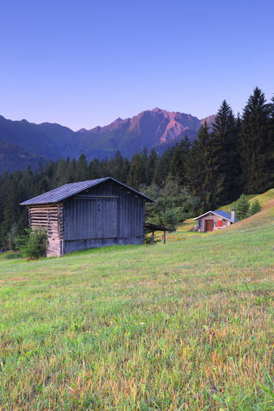 Traditional huts at sunrise. Rhine Gorge(Ruinaulta), Flims, District of Imboden, Canton of Grisons, Switzerland, Europe