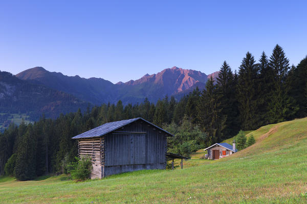 Traditional huts at sunrise. Rhine Gorge(Ruinaulta), Flims, District of Imboden, Canton of Grisons, Switzerland, Europe