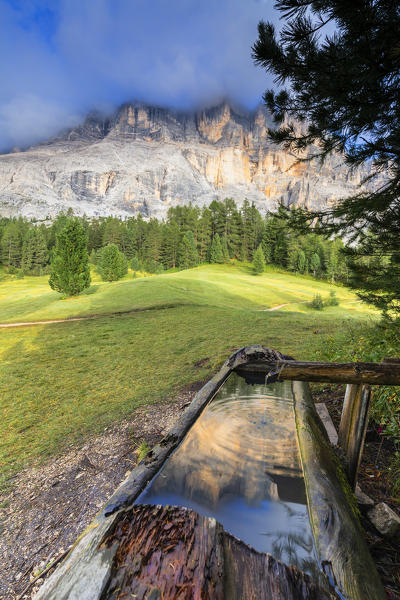 Sasso di Santa Croce is reflected in a fountain. La Valle/La Val/Wengen, Badia Valley, South Tyrol, Dolomites, Italy, Europe.