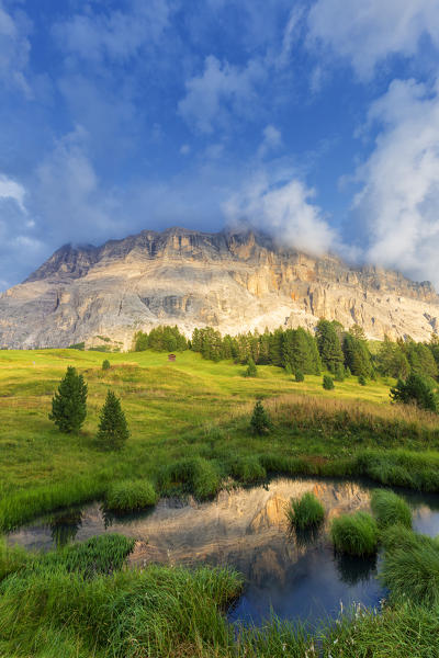 Sasso di Santa Croce is reflected in a pond. La Valle/La Val/Wengen Badia Valley, South Tyrol, Dolomites, Italy, Europe.