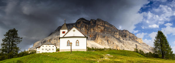 Santa Croce Sanctuary with coming thunderstorm. La Valle/La Val/Wengen Badia Valley, South Tyrol, Dolomites, Italy, Europe.